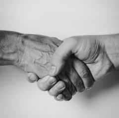 Black and white image of two men shaking hands